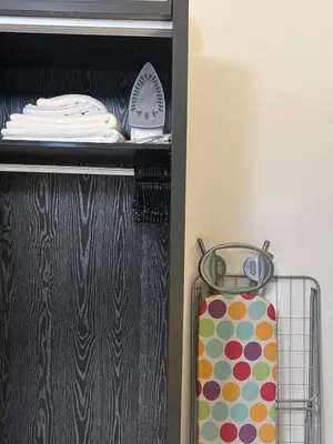 a shelf with a suitcase in a closet at Modern, fully equipped apartment in Jabal Amman in Amman
