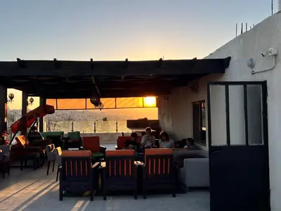 a group of people sitting at a table on a patio at Modern, fully equipped apartment in Jabal Amman in Amman