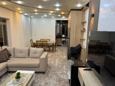 a living room with a couch and a table at شقه مفروشه حديثة ذات أطلالة جميلة ومكان هادئ in Irbid