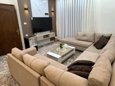a living room with a couch and a tv at شقه مفروشه حديثة ذات أطلالة جميلة ومكان هادئ in Irbid