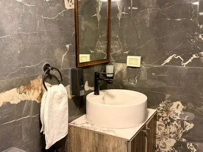 a bathroom with a sink and a mirror at Beit Ahlan in Amman