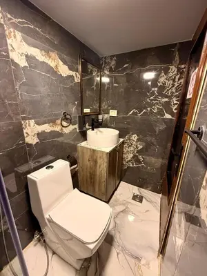 a bathroom with a toilet and a sink at Beit Ahlan in Amman