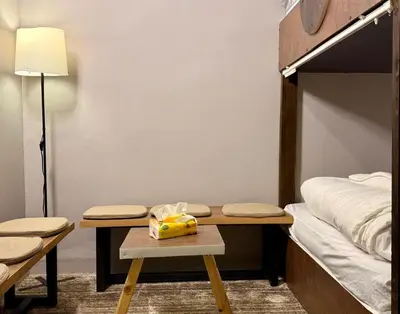 a room with a bed and a table with a bag on it at Beit Ahlan in Amman