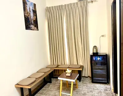 a room with a bench and a table and a window at Beit Ahlan in Amman