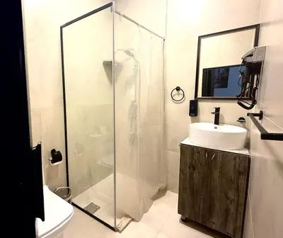 a bathroom with a glass shower and a sink at Beit Ahlan in Amman