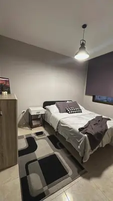 a bedroom with a large bed and a rug at The Elysium in Amman