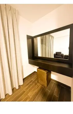 a living room with a mirror and a curtain at الجوهره in Amman