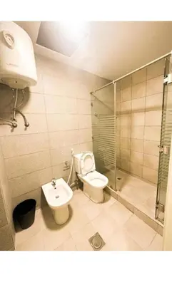 a bathroom with a toilet and a shower and a sink at الجوهره in Amman