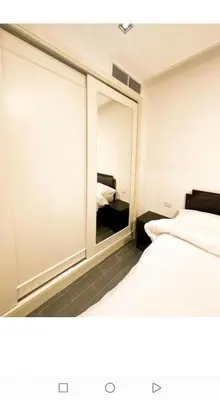 a room with two beds and a large mirror at الجوهره in Amman