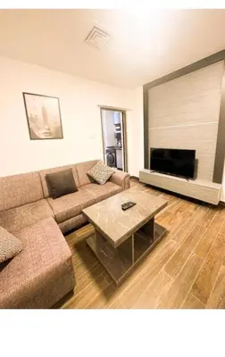 a living room with a couch and a coffee table at الجوهره in Amman