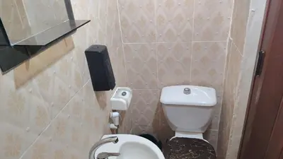a small bathroom with a toilet and a phone on the wall at stone house in Amman