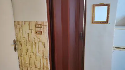 a door that is open to a room with a window at stone house in Amman