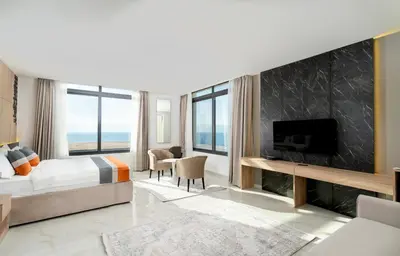 a hotel room with a bed and a fireplace at Diamond Palm Hotel & Resort in Al Burj