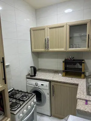 a kitchen with a stove and a washing machine at عمان in Amman