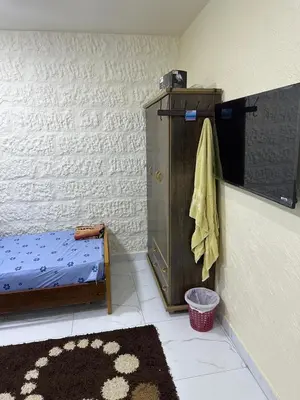 a room with a bed and a towel on a wall at عمان in Amman