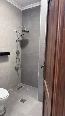 a bathroom with a shower and a toilet at One bedroom near University of Jordan in Amman
