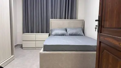a bedroom with a bed and a window at One bedroom near University of Jordan in Amman