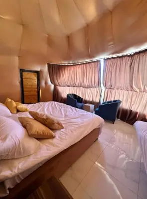 a bedroom with a large bed in a room at Olivia Rum Luxury Bubbles & Jeep Tours in Wadi Rum