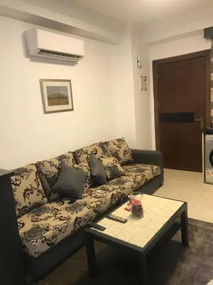 a living room with a couch and a coffee table at Abdoun studio in Amman