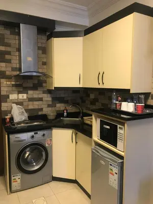 a kitchen with a washing machine and a dishwasher at Abdoun studio in Amman