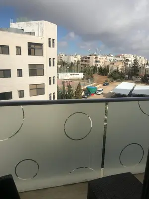 a balcony with a view of a city at Abdoun studio in Amman