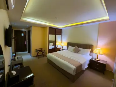 a hotel room with a bed and a television at 7Wonders by TREND in Petra