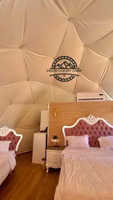 a room with two beds in a tent at Grand Bubble rum luxury in Wadi Rum