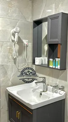 a bathroom with a sink and a hair dryer at Grand Bubble rum luxury in Wadi Rum