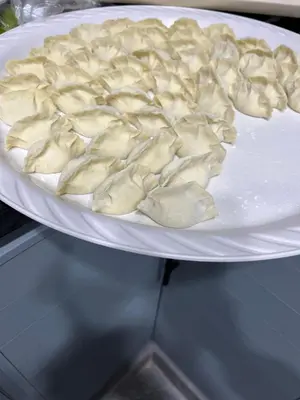 a plate of dumplings on a white plate at \u9f99\u95e8\u5ba2\u6808 in Amman