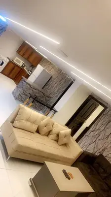a living room with a couch and a fireplace at CityHaven in Amman
