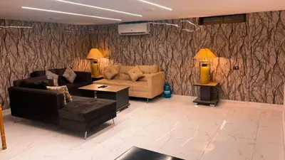 a living room with couches and a couch and a table at CityHaven in Amman