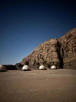 a rock formation in the middle of the desert at HOlIDAY LUXURY WADI RUM in Wadi Rum