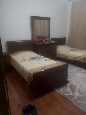 a room with two beds and a mirror at جبيهه in Amman