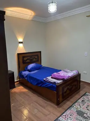 a bedroom with a bed with blue sheets and purple pillows at Doven Farm in Wadi Musa