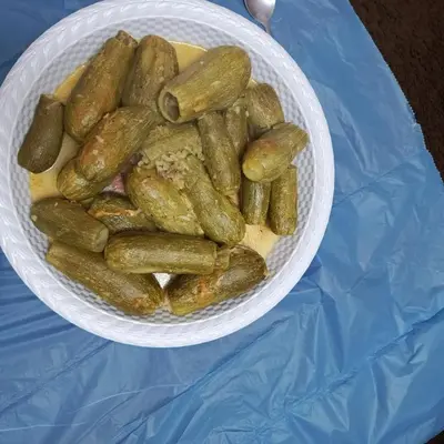 a white bowl of pickles on a table at Doven Farm in Wadi Musa