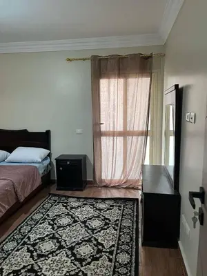 a bedroom with a bed and a window with a rug at Doven Farm in Wadi Musa