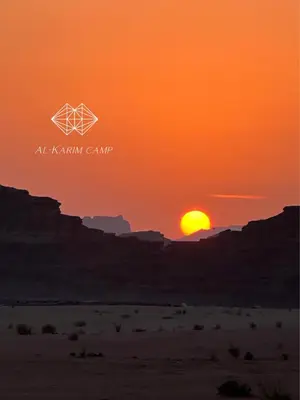 an orange sunset in the desert with a geometric sign at Alkaram luxury camp in Wadi Rum