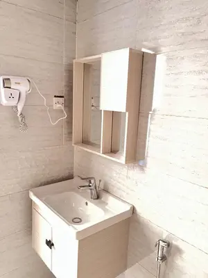 a white bathroom with a sink and a mirror at Rum STAR LUXURY Camp &JEEP Tours in Wadi Rum
