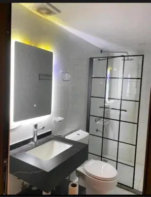 a bathroom with a sink and a toilet and a mirror at Rum STAR LUXURY Camp &JEEP Tours in Wadi Rum