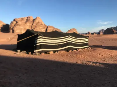 a black and white tent in the desert at Bedouin house in Wadi Rum