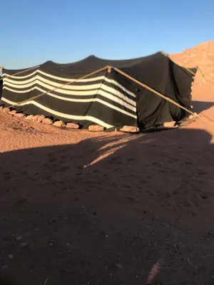 a tent sitting on the ground in the desert at Bedouin house in Wadi Rum