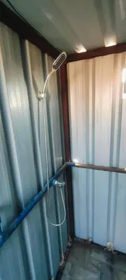 a shower in the corner of a room at Wadi Ghowair View Camp in Al Khuraybah