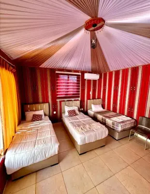 a room with three beds in a tent at مخيم وهج رم in Disah