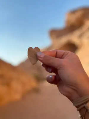 a person holding a coin in their hand at Rum drone tours in Aqaba