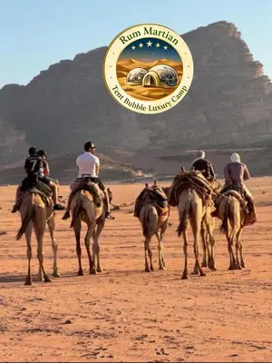 a group of people riding horses in the desert at RUM MARTIAN TENT BUBBLES lUXURY CAMP in Wadi Rum