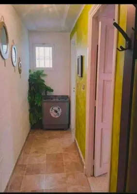 a hallway with a room with a door and a television at Loard House in Az Zarqa