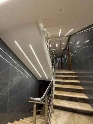 a set of stairs in a building with metal railing at 3bedroom apart Deir Ghbar JRE in Amman