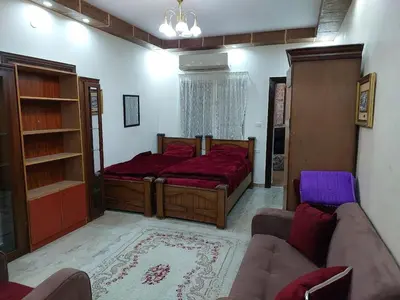 a bedroom with a large bed and a couch at Nice comfy room in Amman