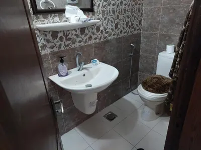 a bathroom with a sink and a toilet at Nice comfy room in Amman