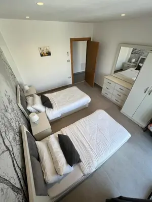 a bedroom with two beds and a mirror at Eva chalet in Deadsea in Al Kafrayn